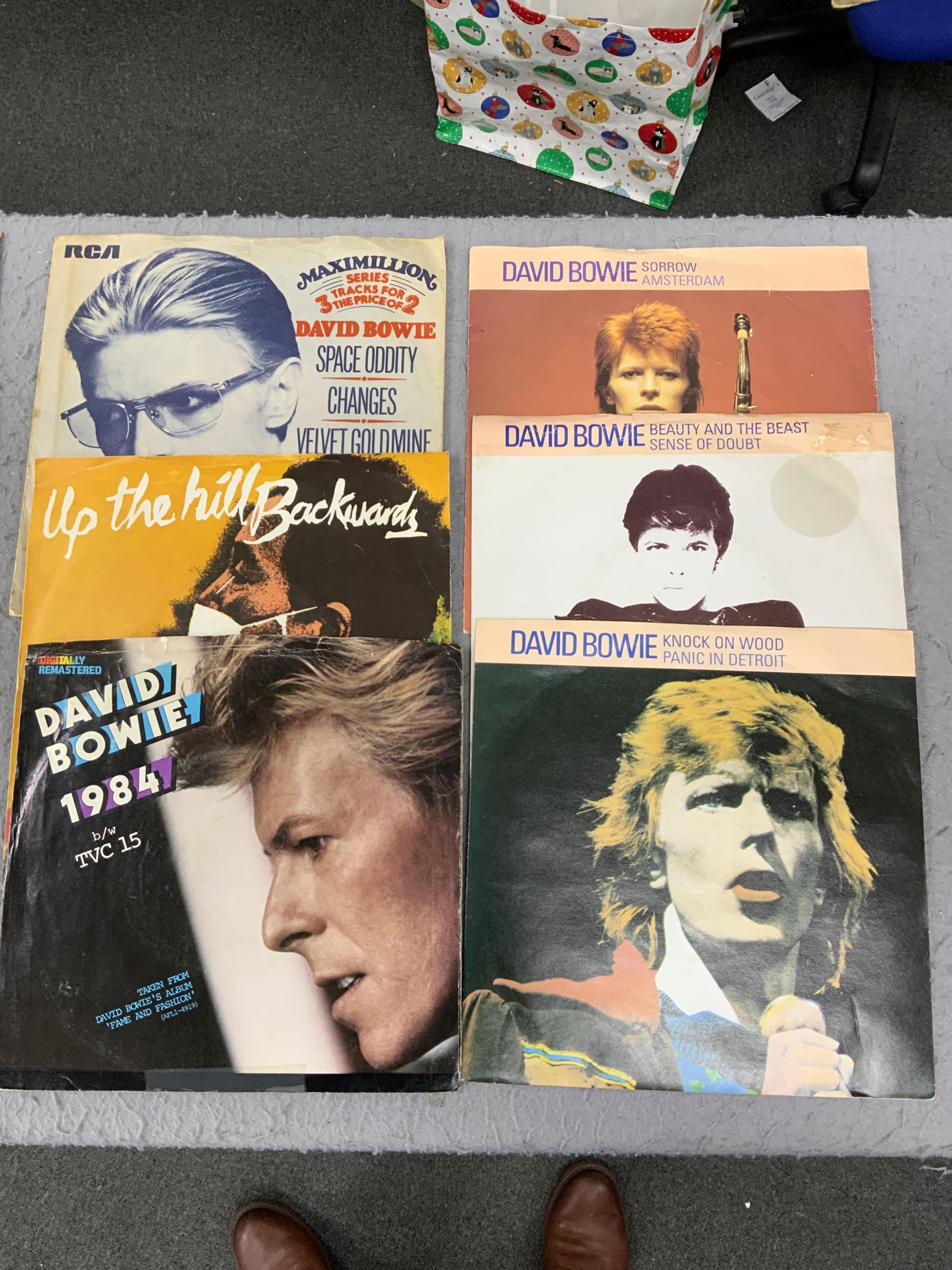 Four 7” single carry cases, containing singles on labels including; Brunswick, Decca, HMV, Pye, Columbia, etc. artists including; Bill Haley, Rod Stewart, David Bowie, Buddy Holly, Gene Vincent, Cliff Richard, Tommy Stee